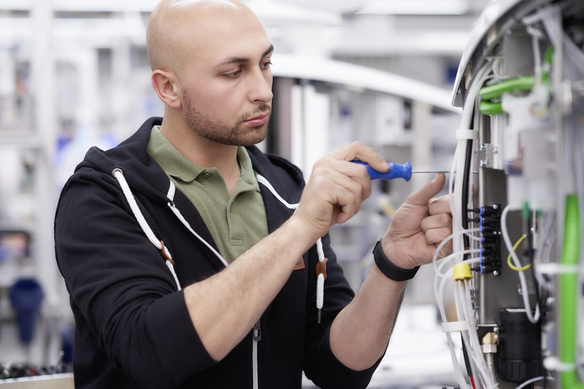 A man fixing a dental chair