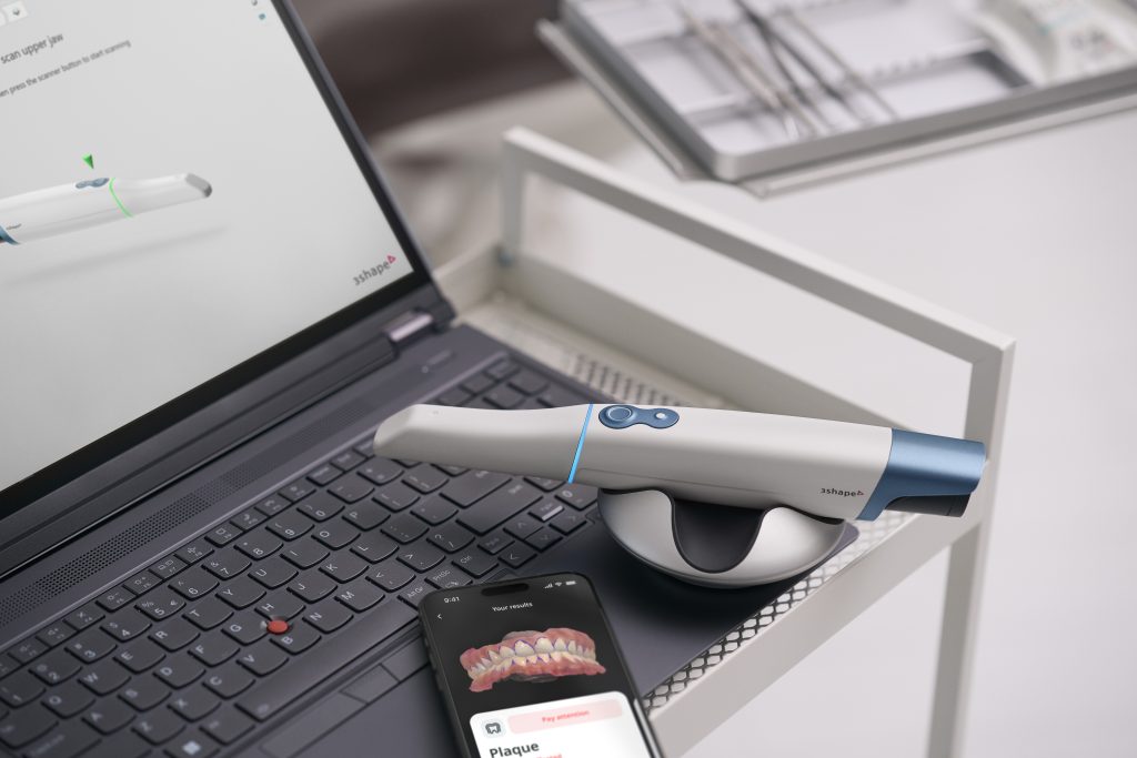 TRIOS 6 scanner on laptop beside phone