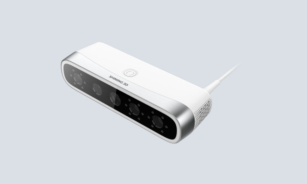 Compact intraoral scanner with ergonomic handheld design resting on charging pod